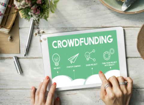 A tablet with the word crowdfunding